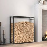 Matt black steel firewood rack holding stacked logs beside a fireplace.